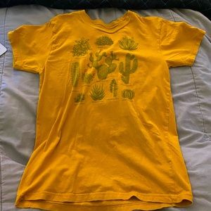 Marigold shirt with 11 different types of cacti on it with names